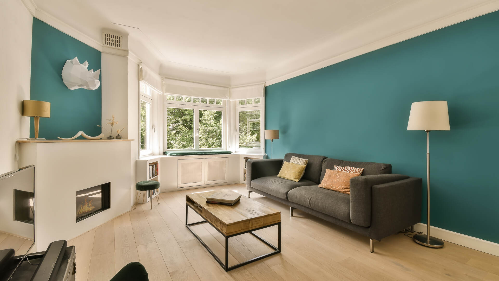 Living room with a teal accent wall, interior painting in Lakeland FL