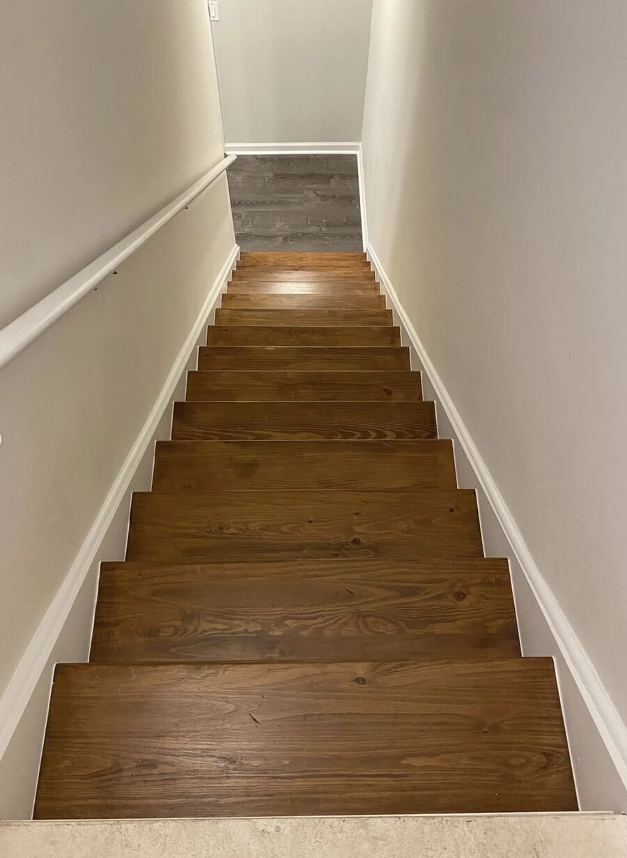 Same staircase after Hue Painting stained and sealed the treads with white trim, Lakeland FL