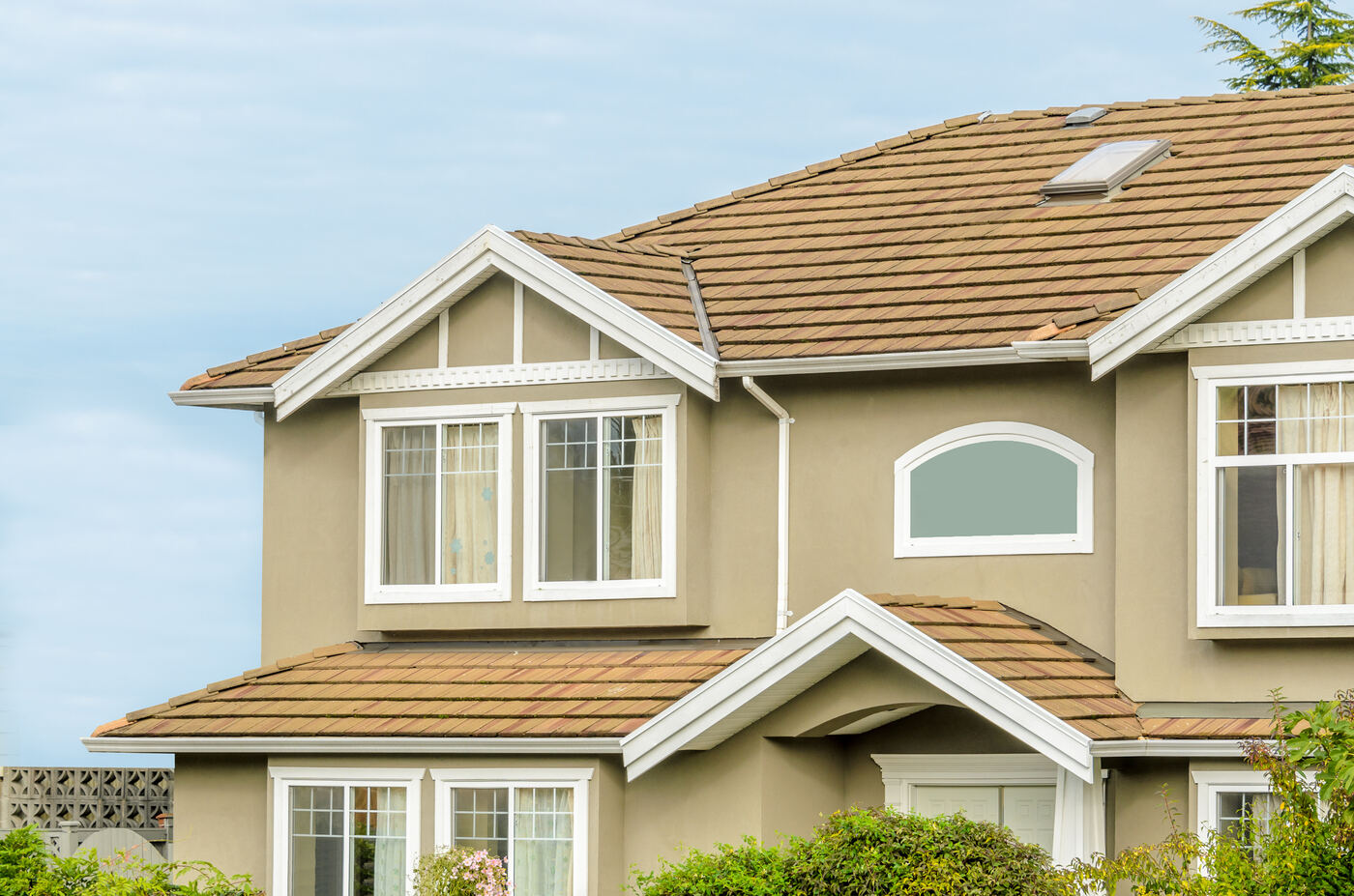 Tan two-story stucco home with white windows, exterior painting in Polk County FL